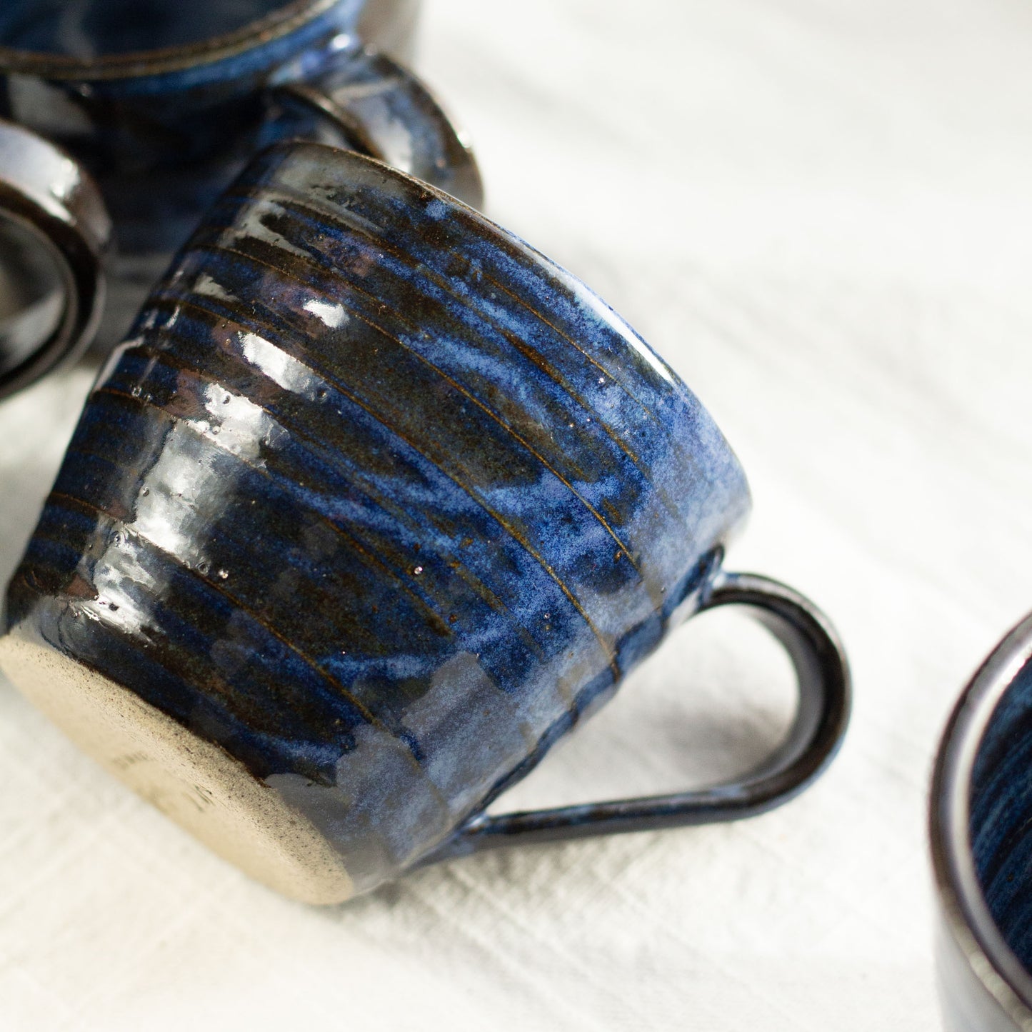 Blue ceramic mug with a textured surface on a white background